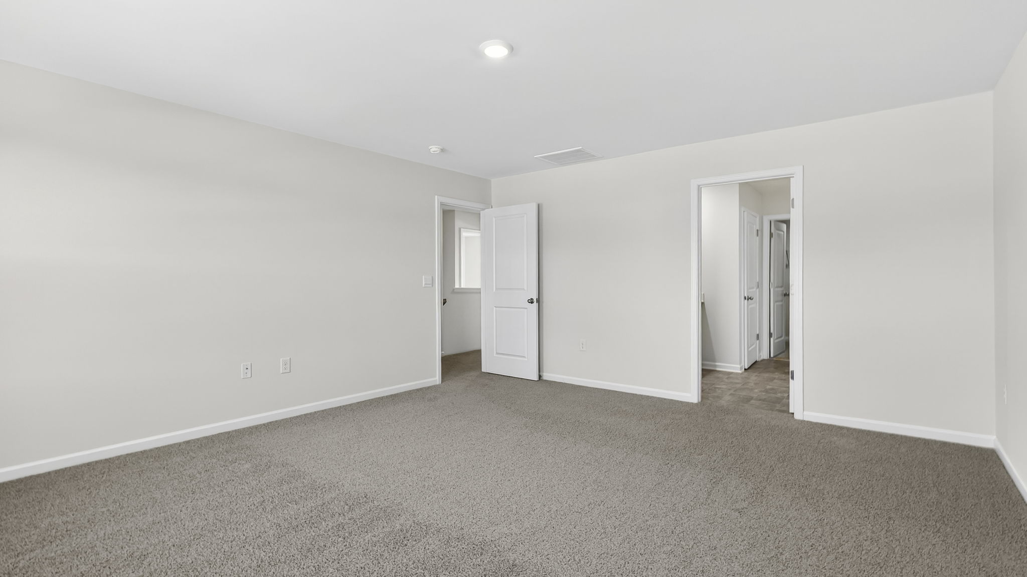 Bedroom with carpet and window.