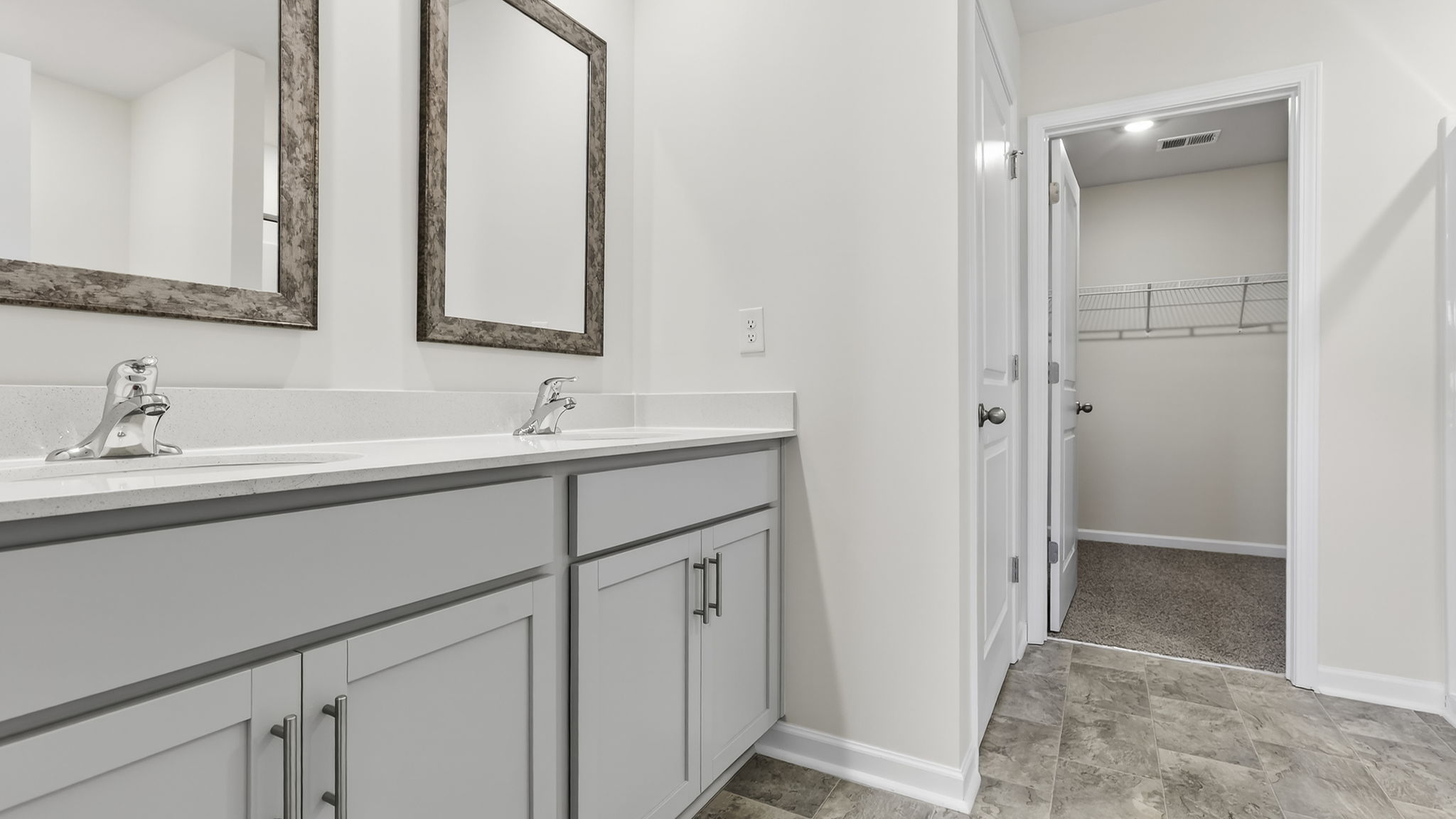 Bathroom with double vanity sink and closet.
