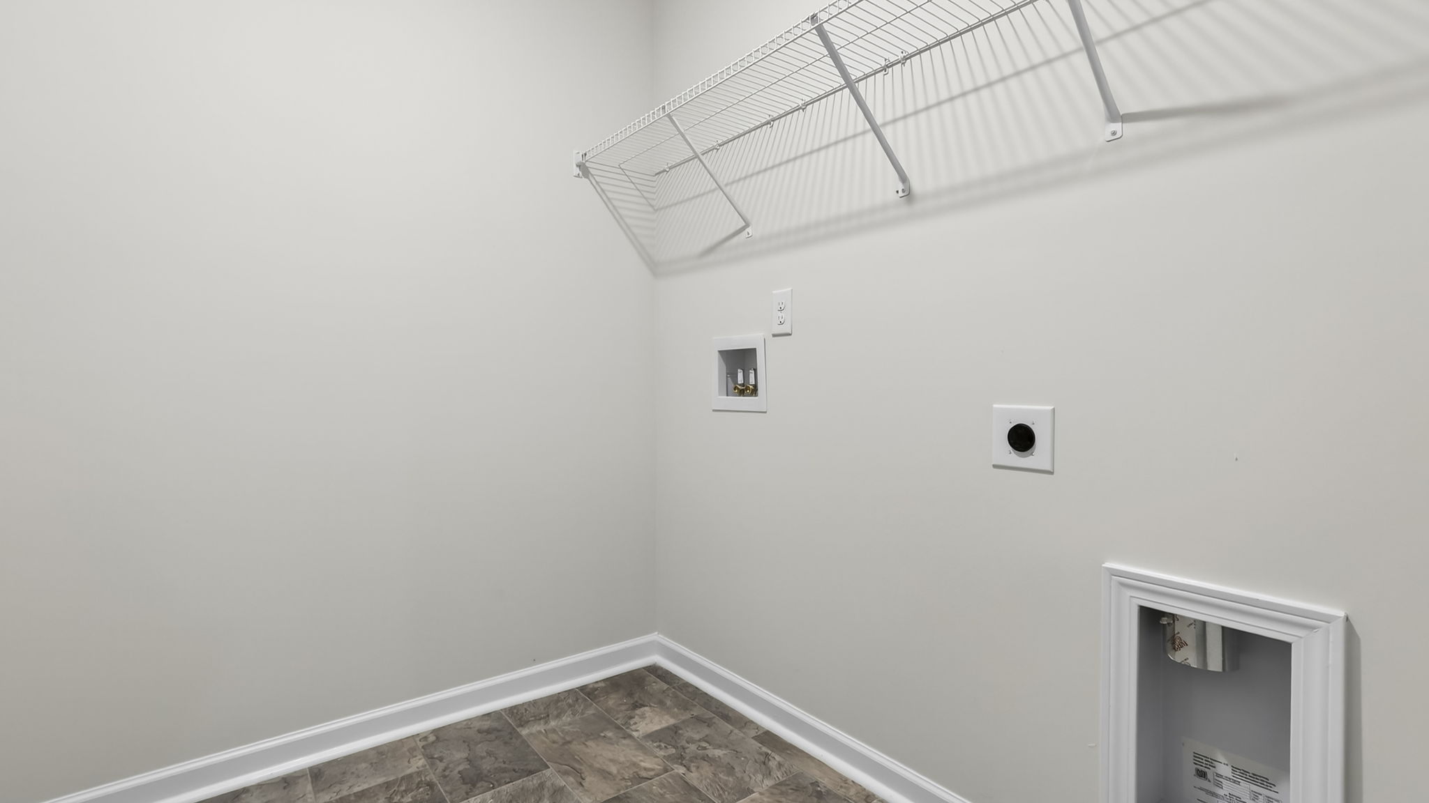 Laundry room with hanging storage racks.