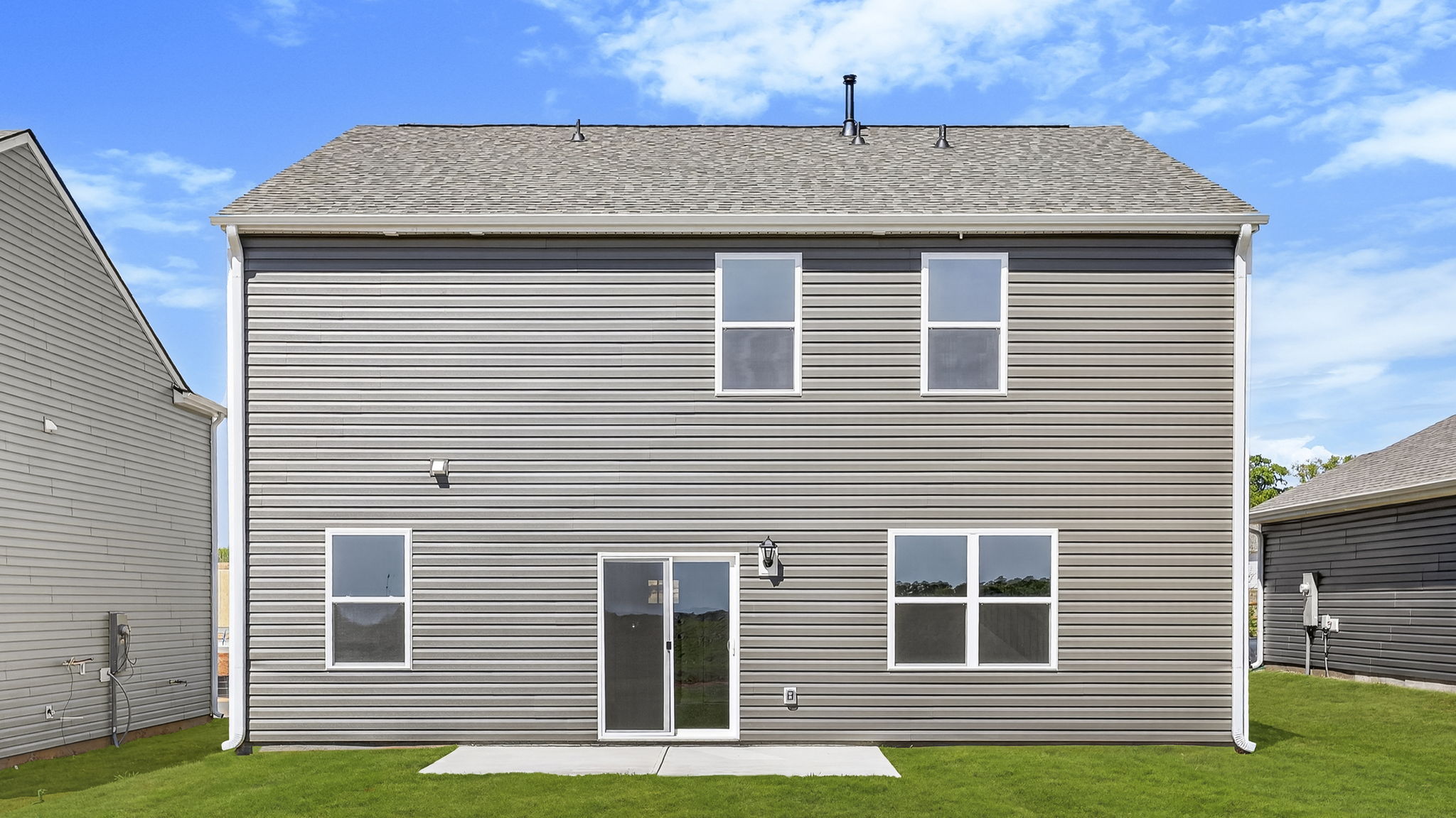 Back exterior of home with large backyard.