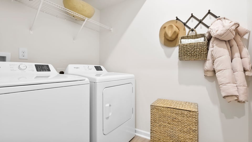 Laundry room with hanging storage racks.