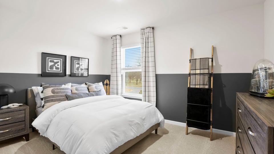 Bedroom with carpet and windows.