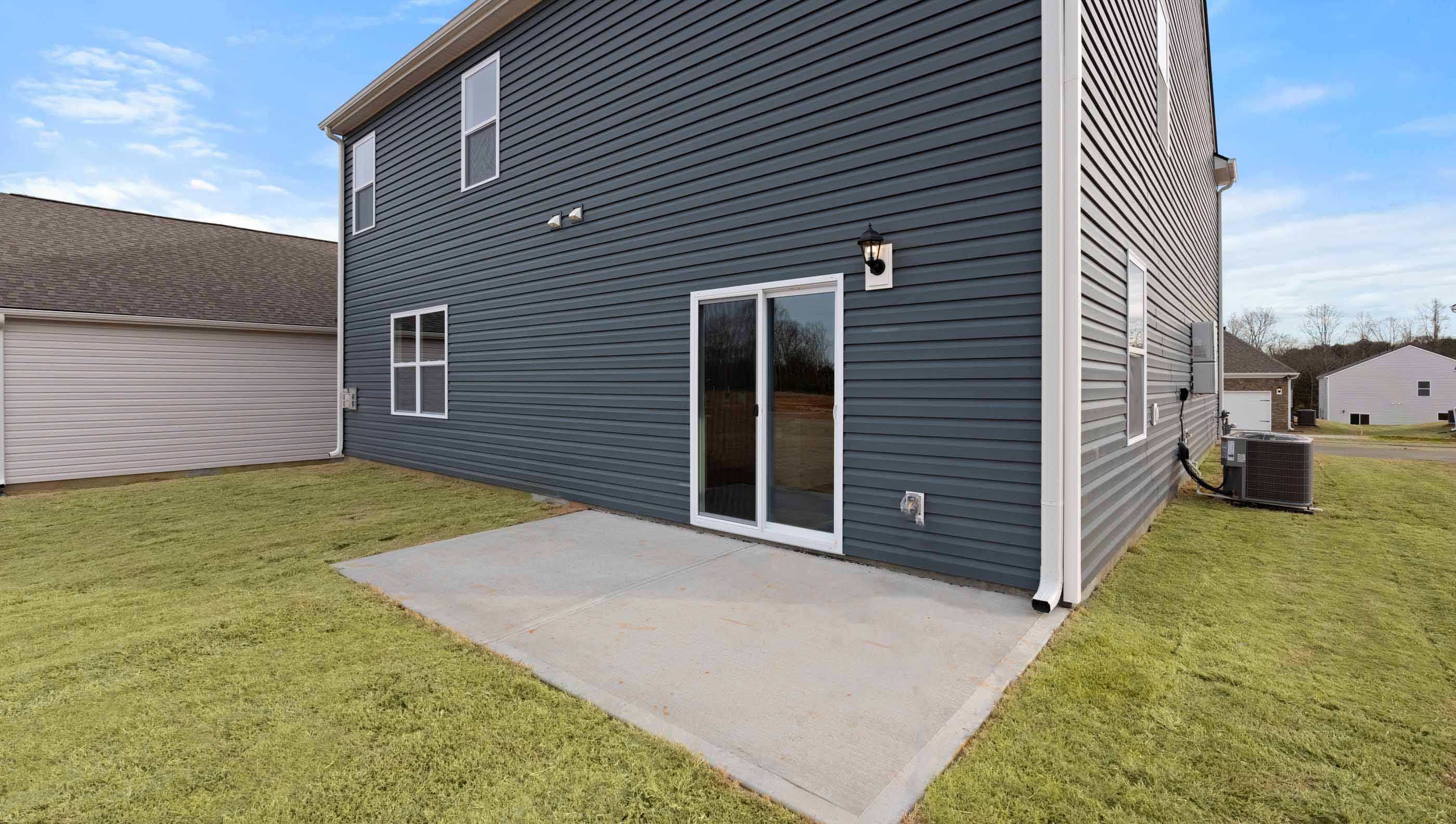 Back exterior of home with patio.