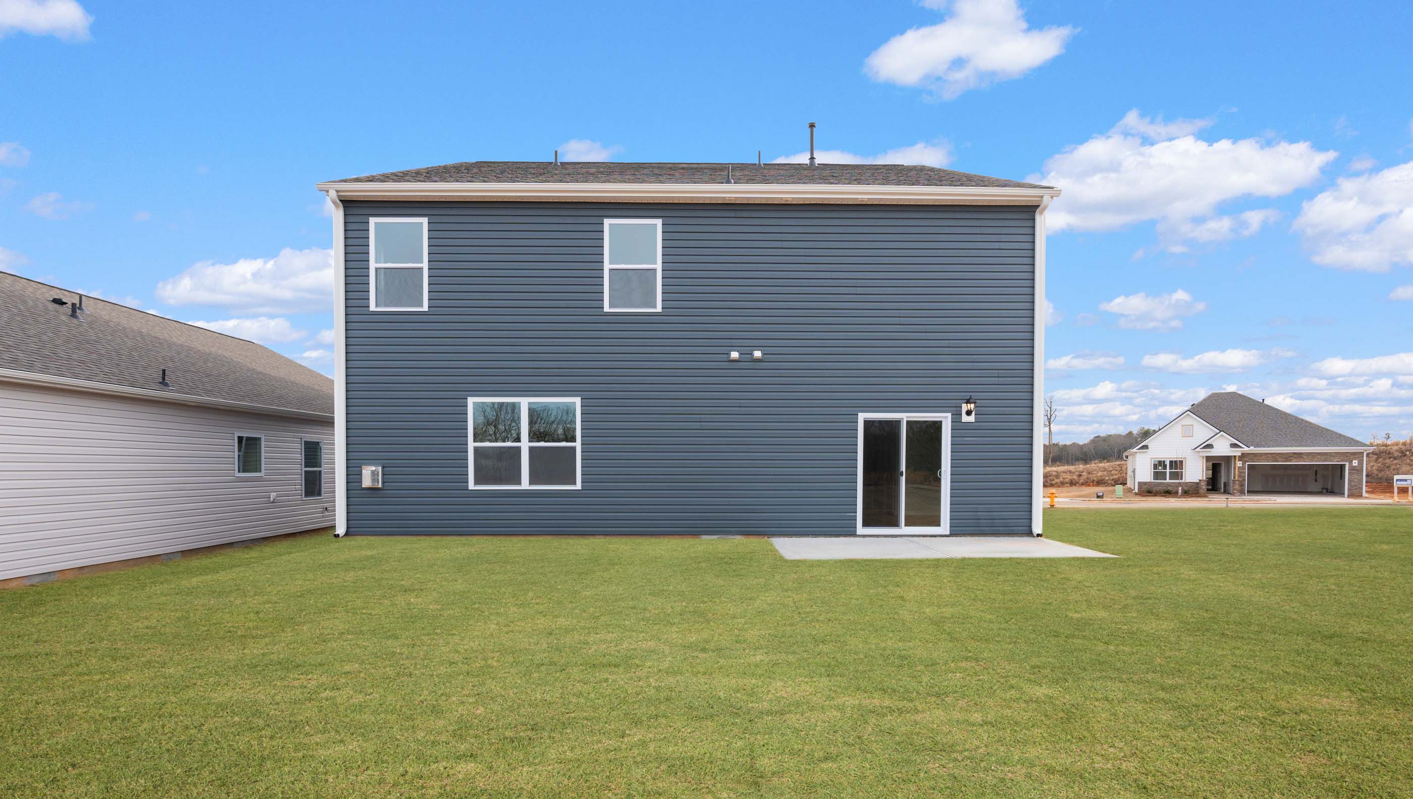 Back exterior of home with large backyard.