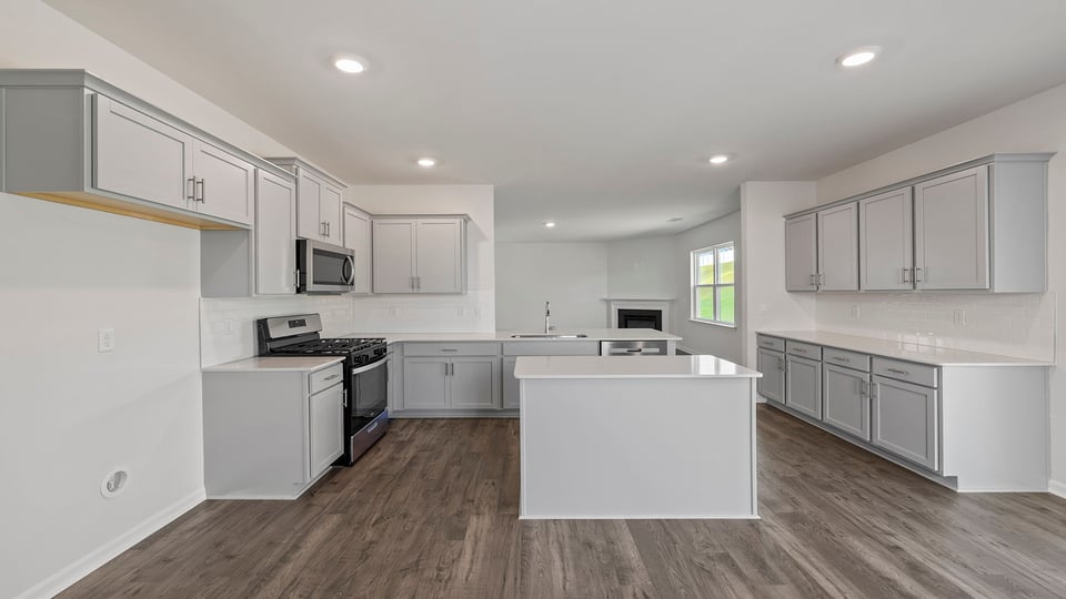 Kitchen with granite countertops with stainless steel appliances.