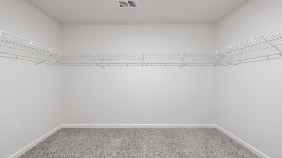 Walk in closet with shelves.