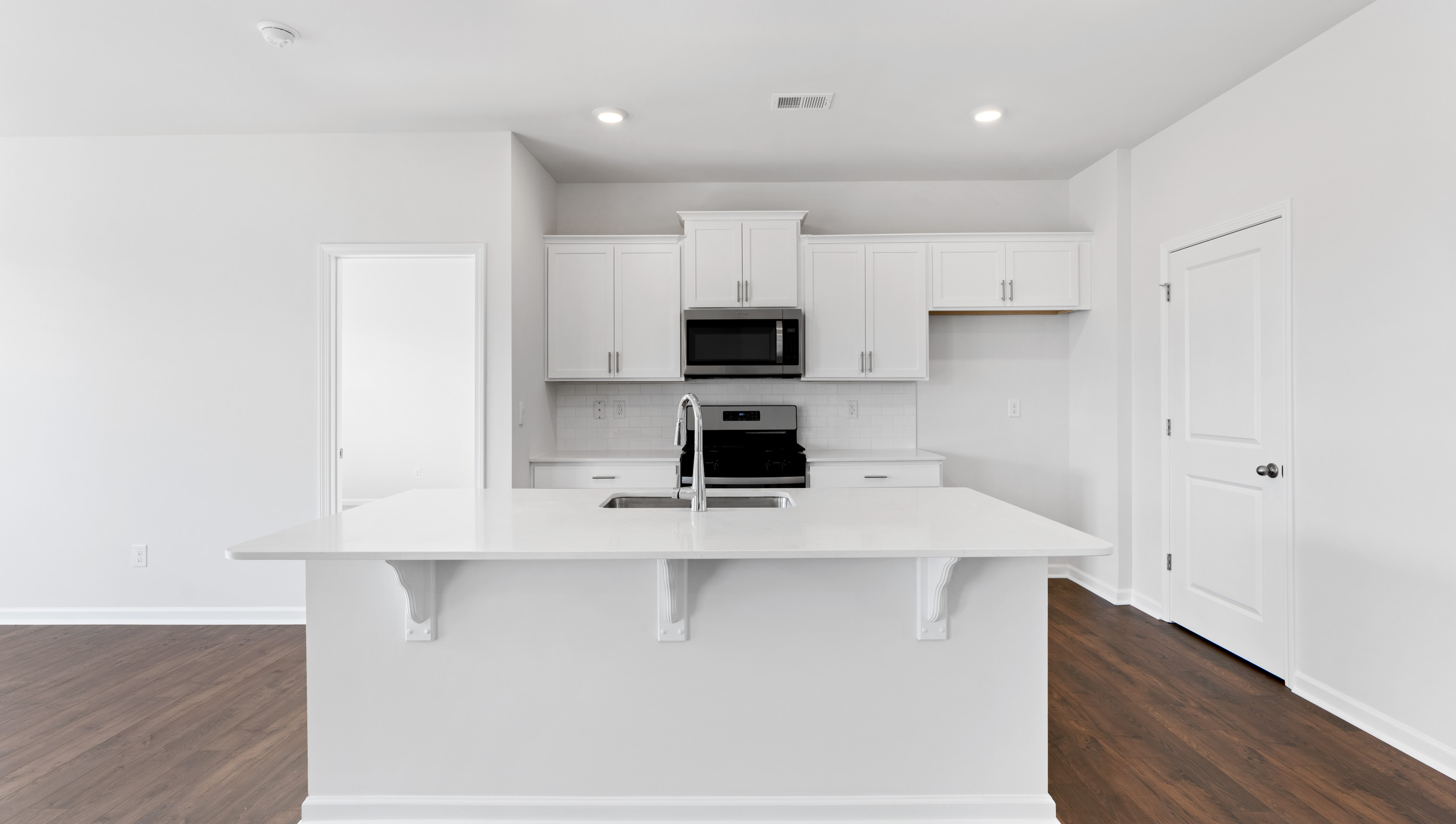 Kitchen and island with granite counter tops.