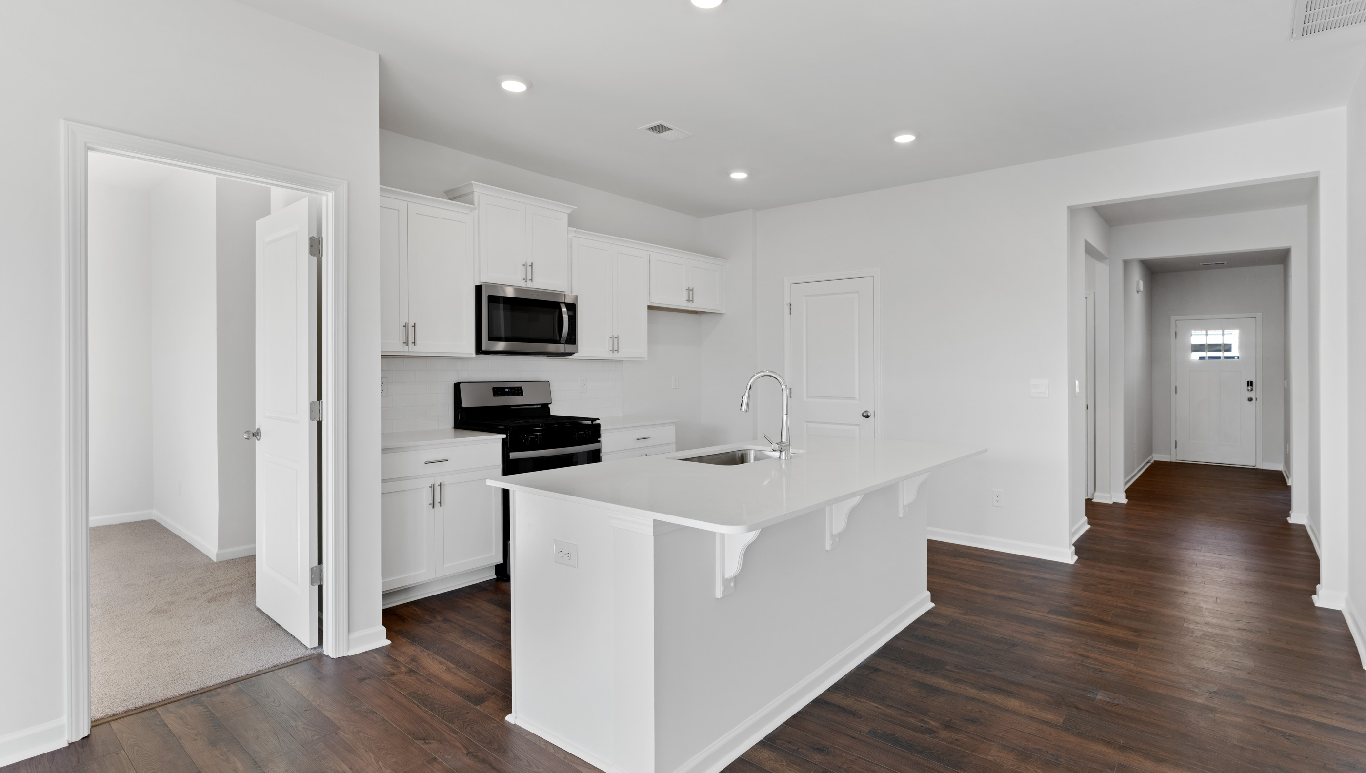 Kitchen and island with granite counter tops.