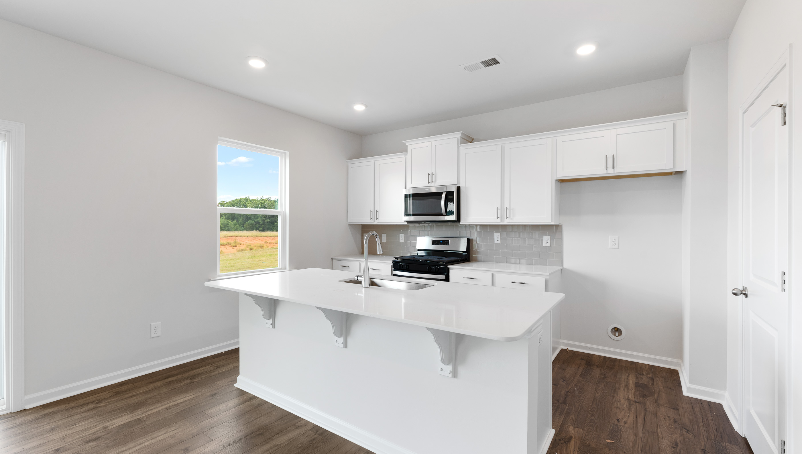 Kitchen and island with granite counter tops.