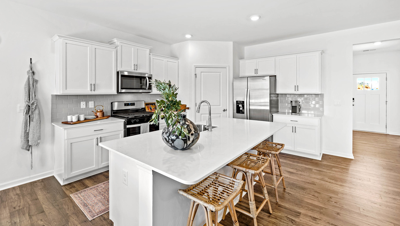 Kitchen and island with granite counter tops.