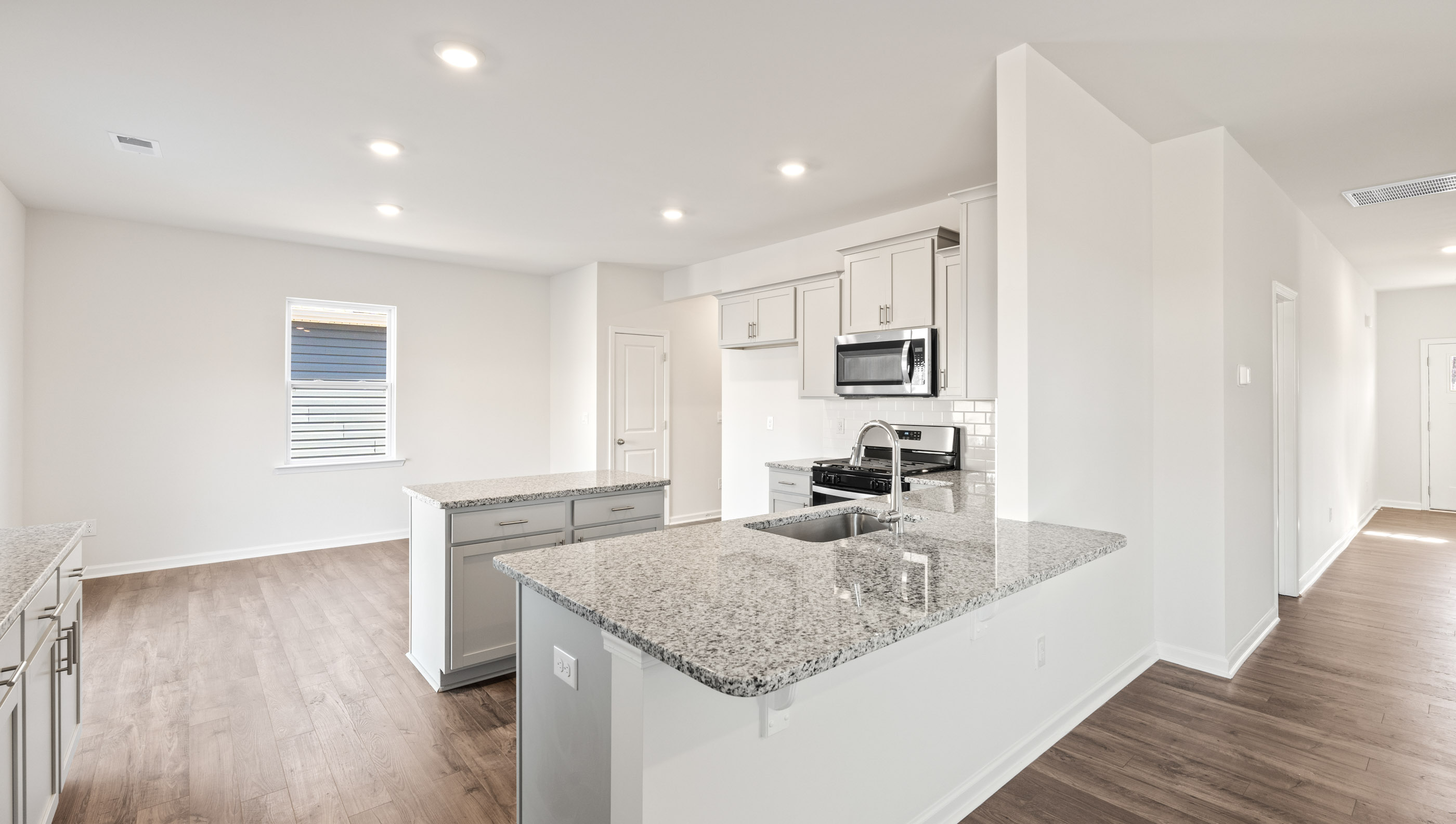 Kitchen and island with granite counter tops.