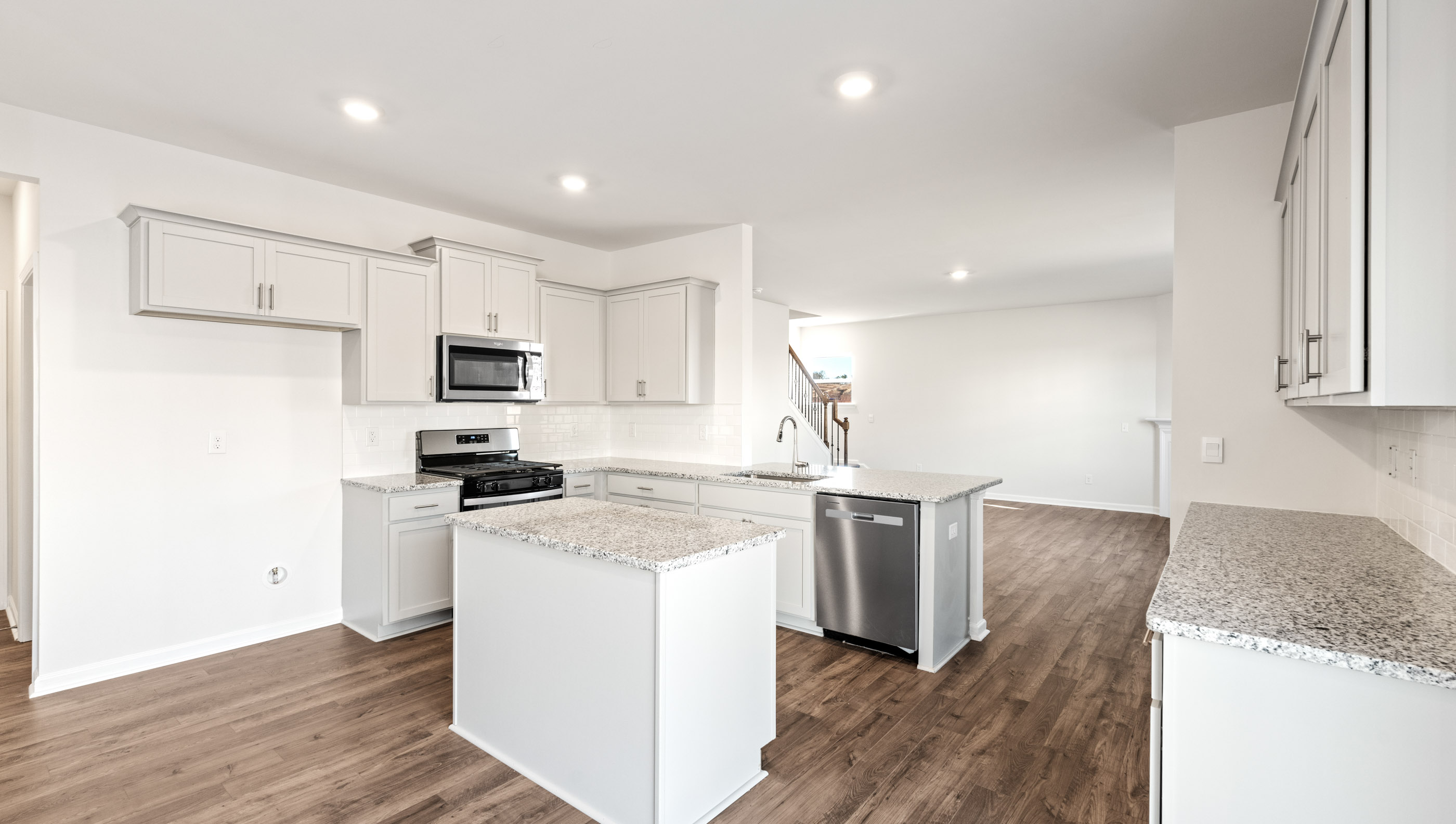 Kitchen and island with granite counter tops.
