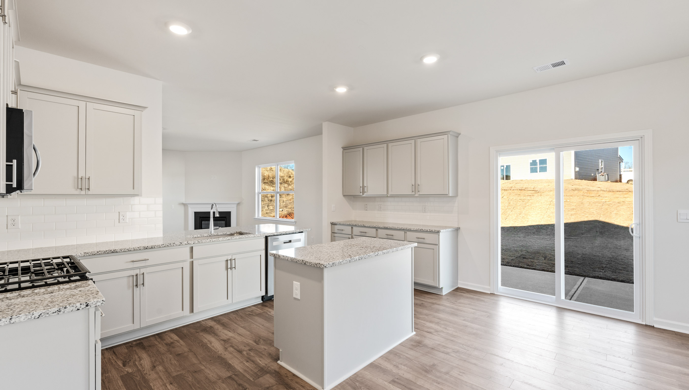 Kitchen and island with granite counter tops.