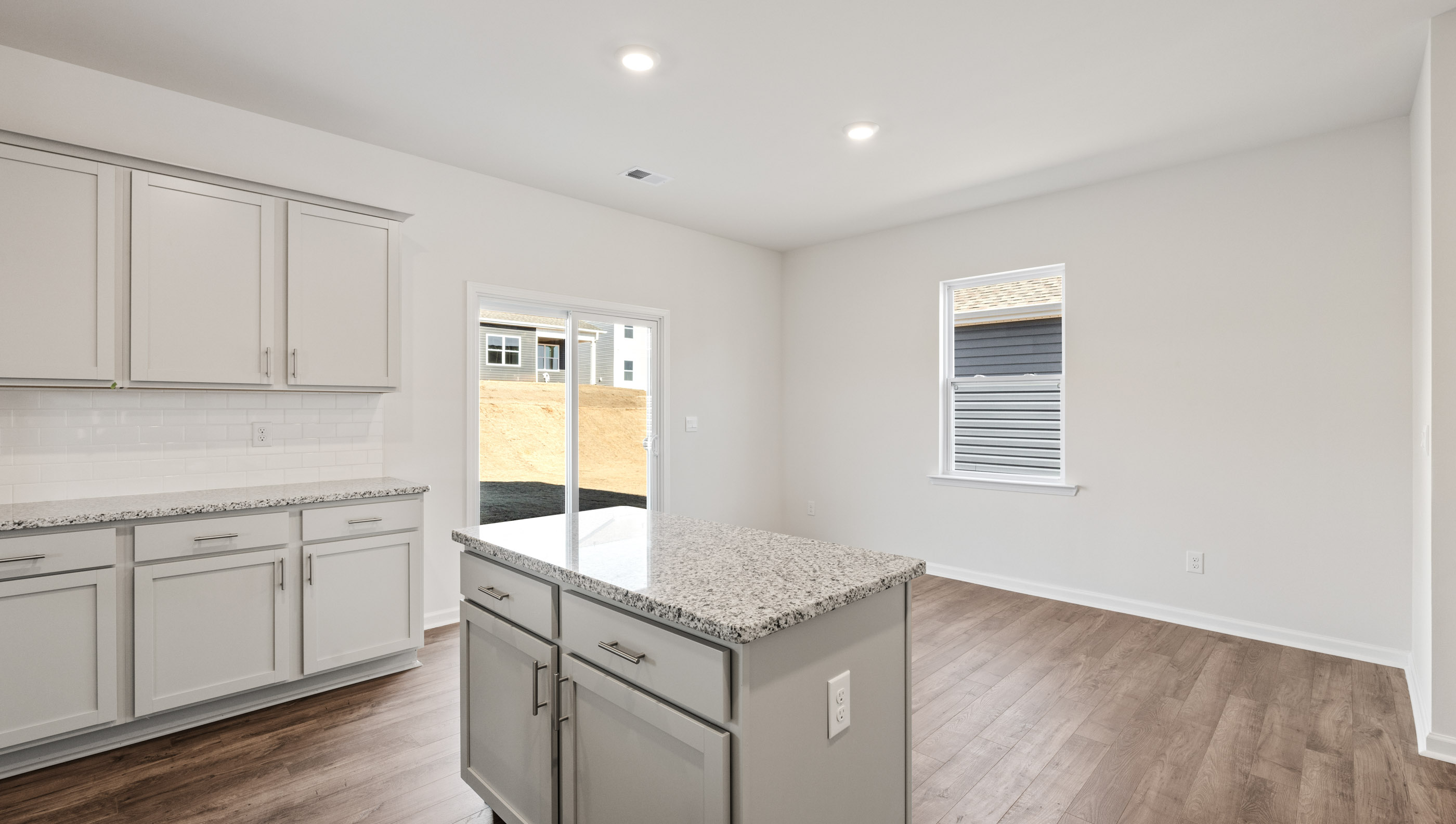 Kitchen and island with granite counter tops.