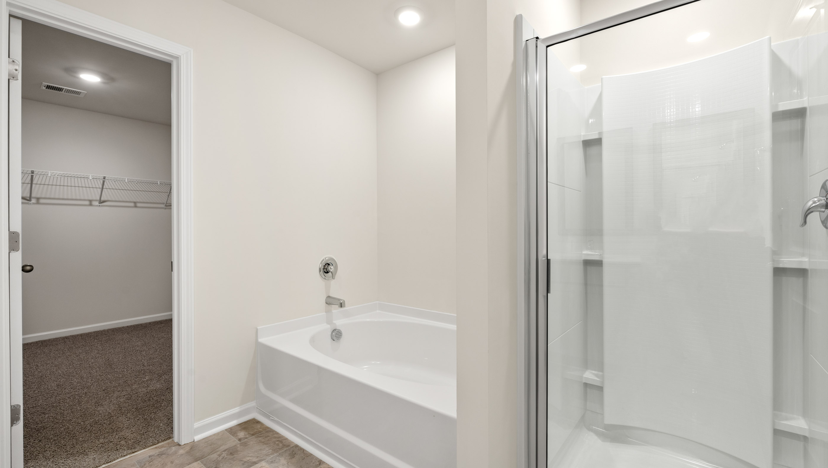 Bathroom with tub and walk in shower.