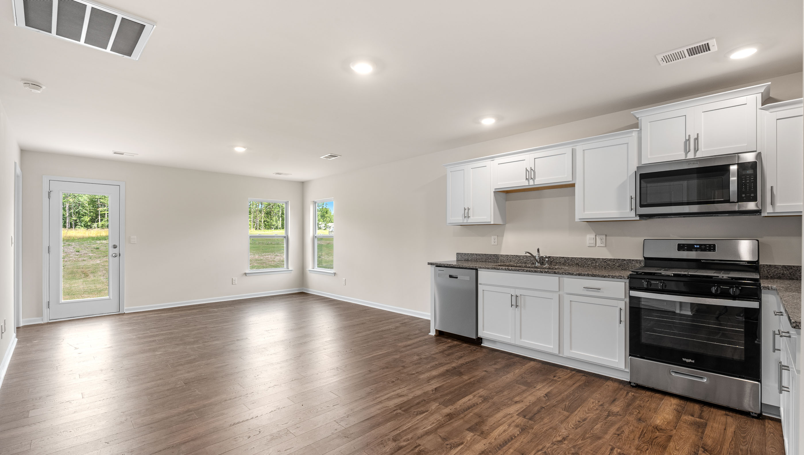Kitchen and living room with windows.