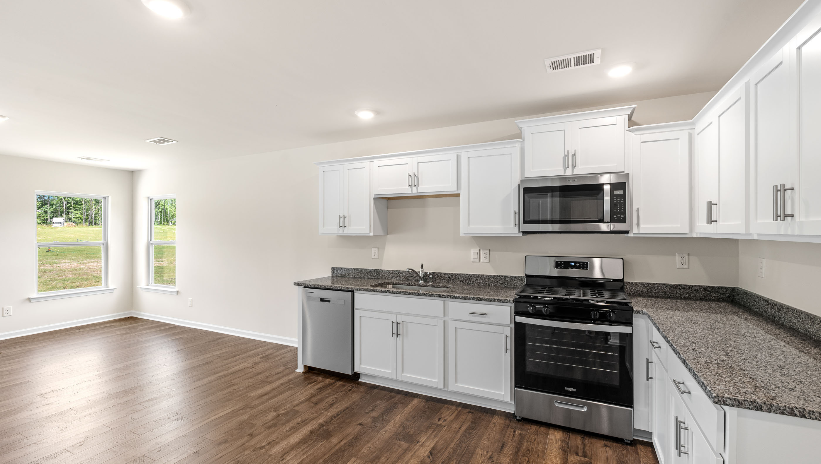 Kitchen and living room with windows.