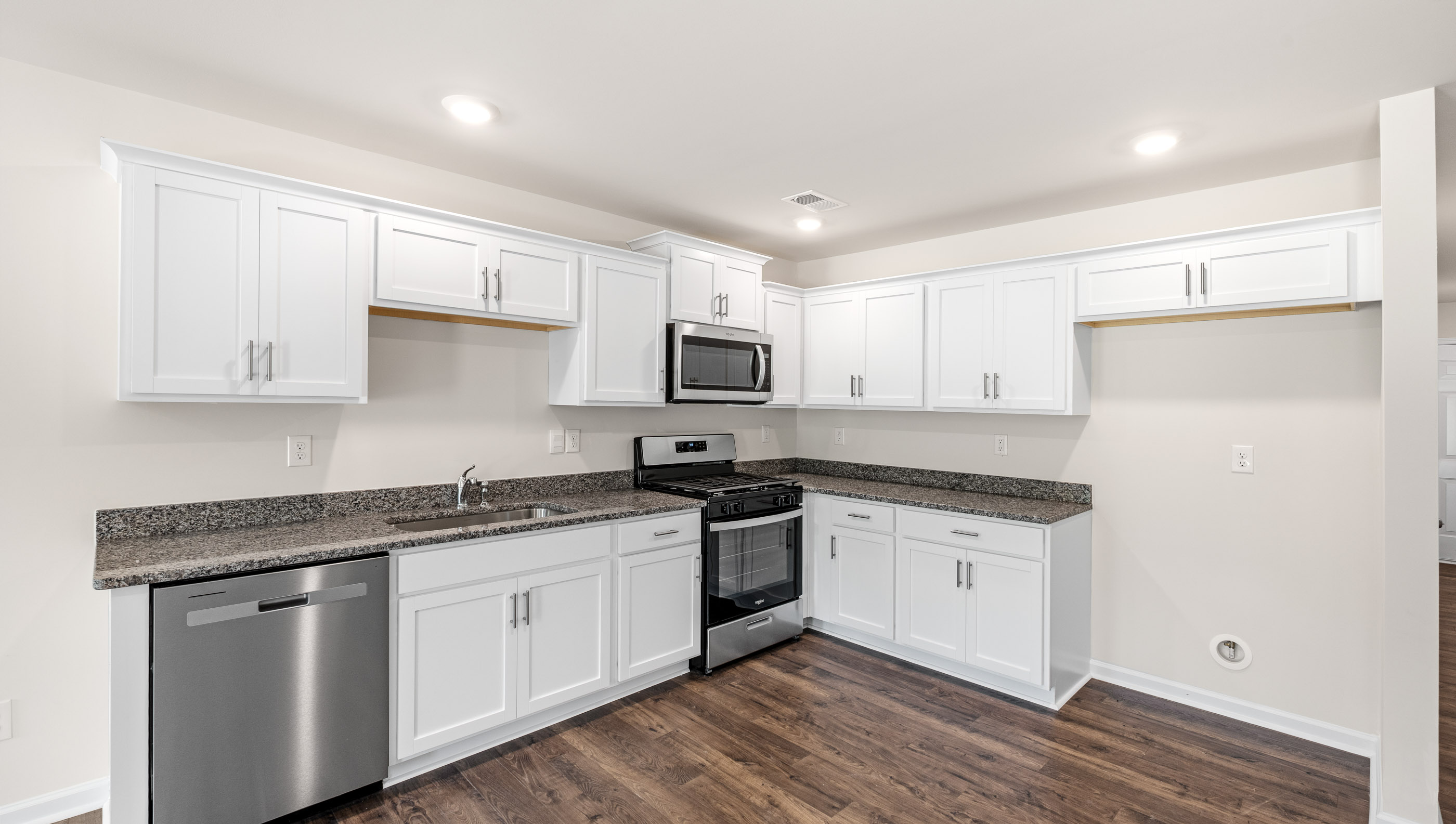 Kitchen with granite countertops and stainless steel appliances.