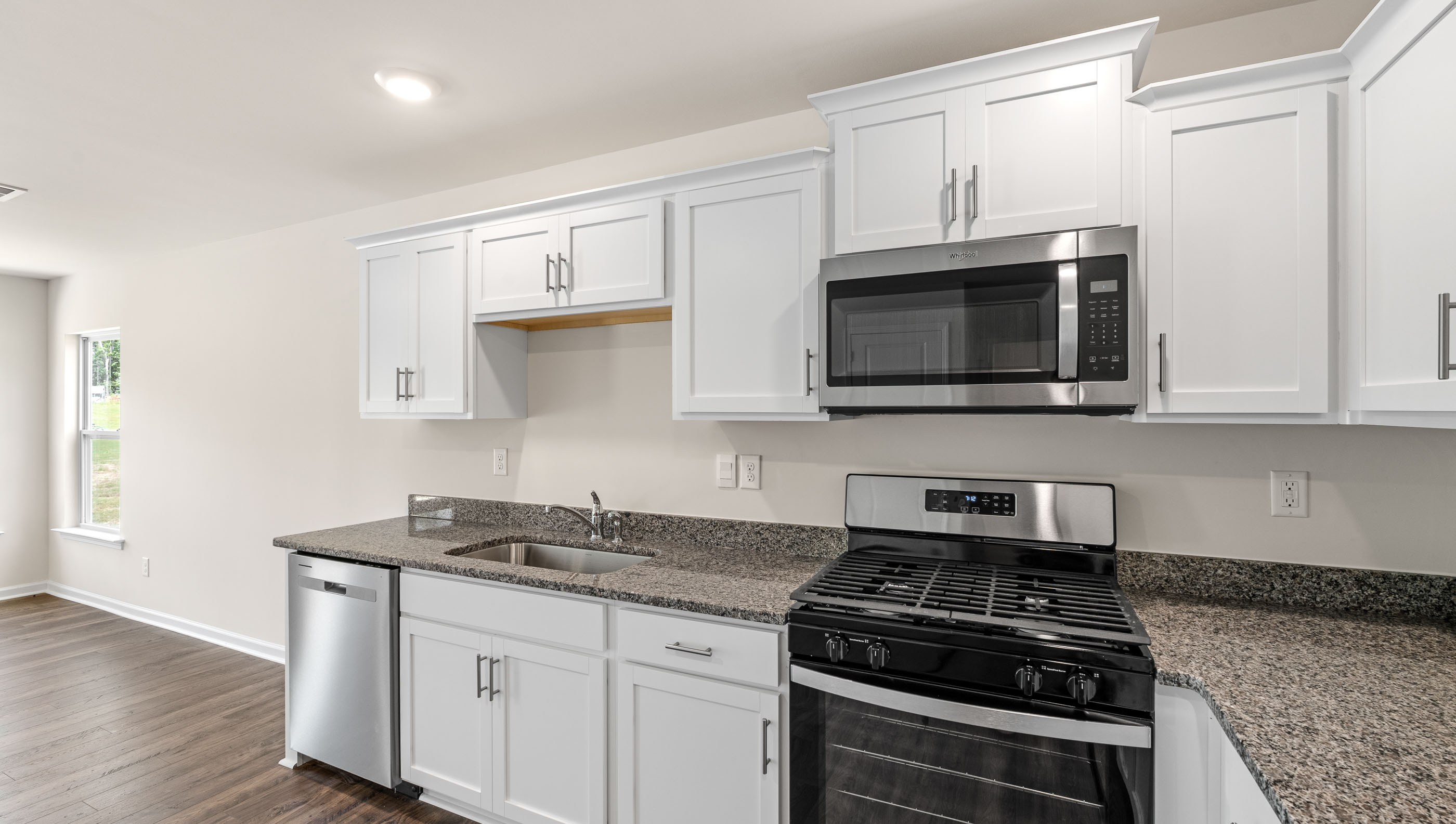 Kitchen with granite countertops and stainless steel appliances.