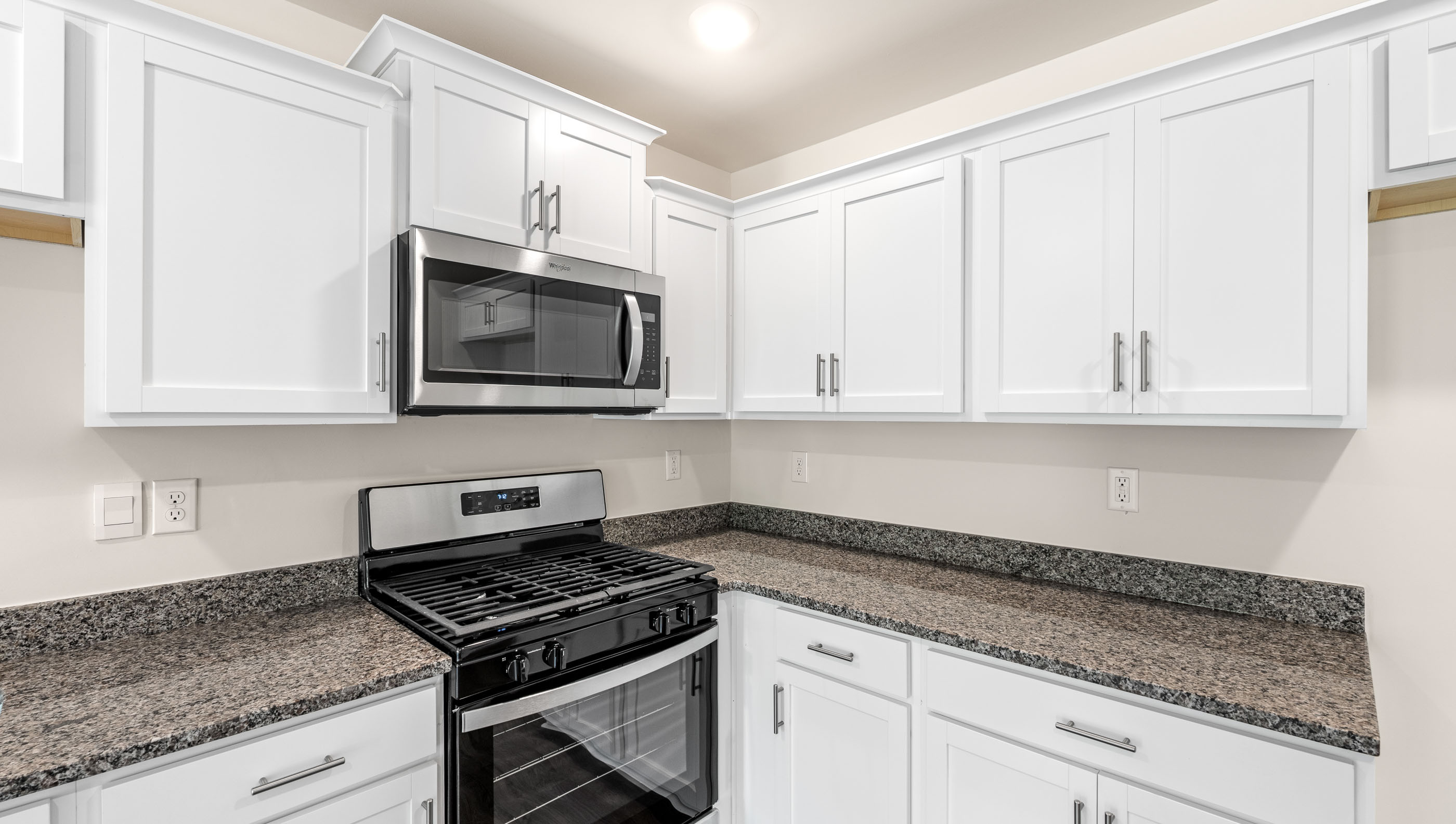 Kitchen with granite countertops and stainless steel appliances.