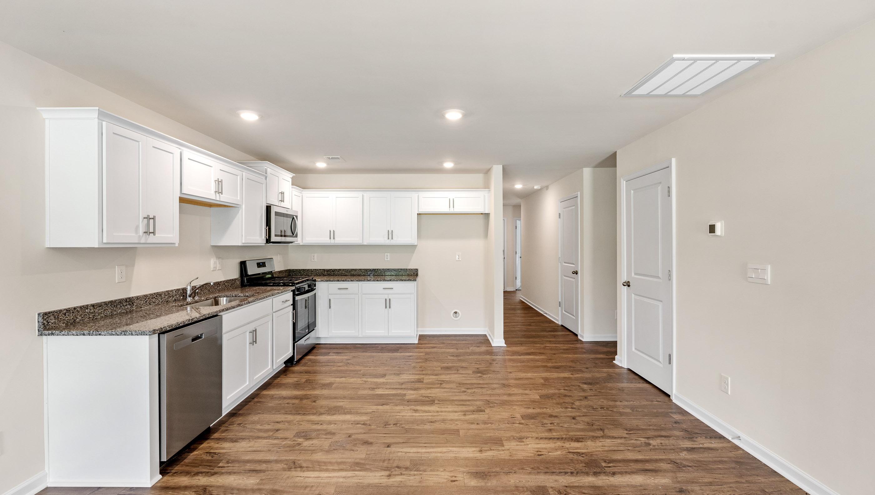 Kitchen with granite countertops and stainless steel appliances.