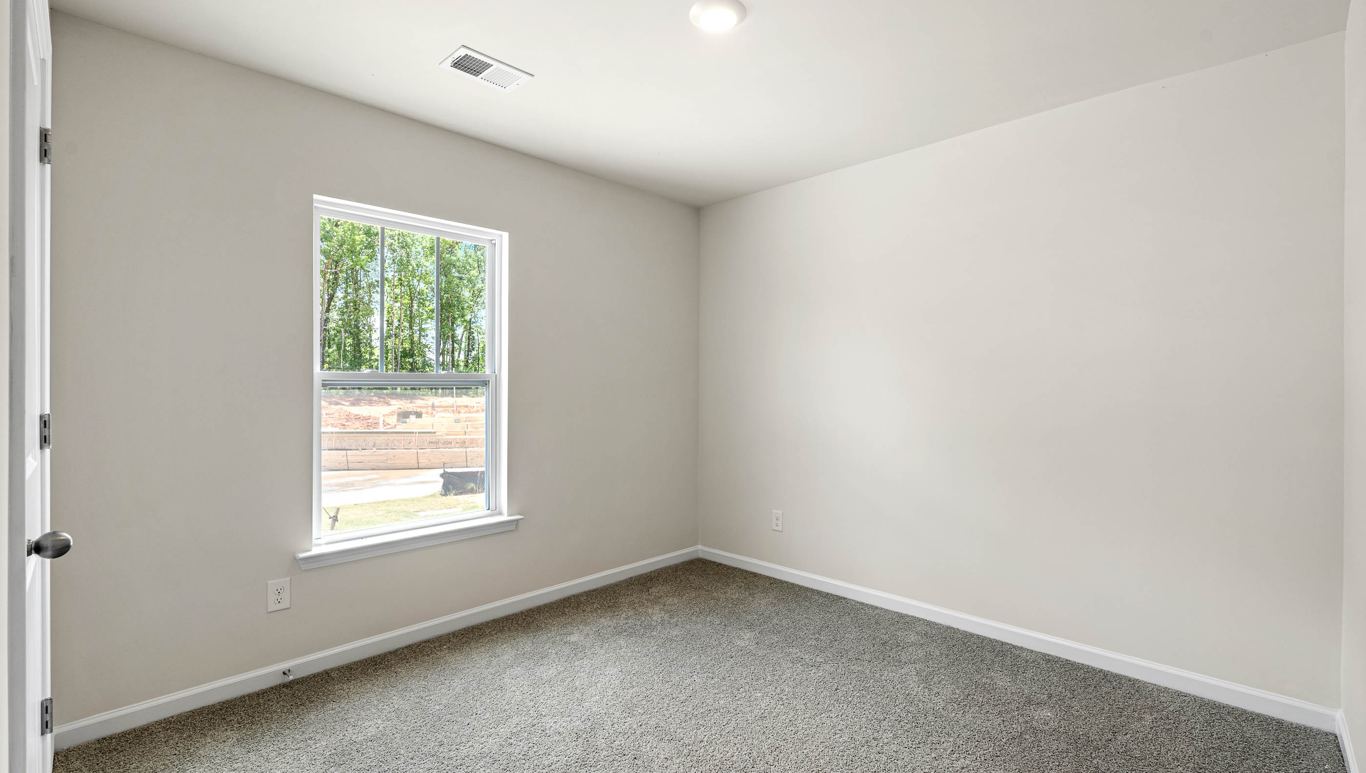 Bedroom with carpet and windows.
