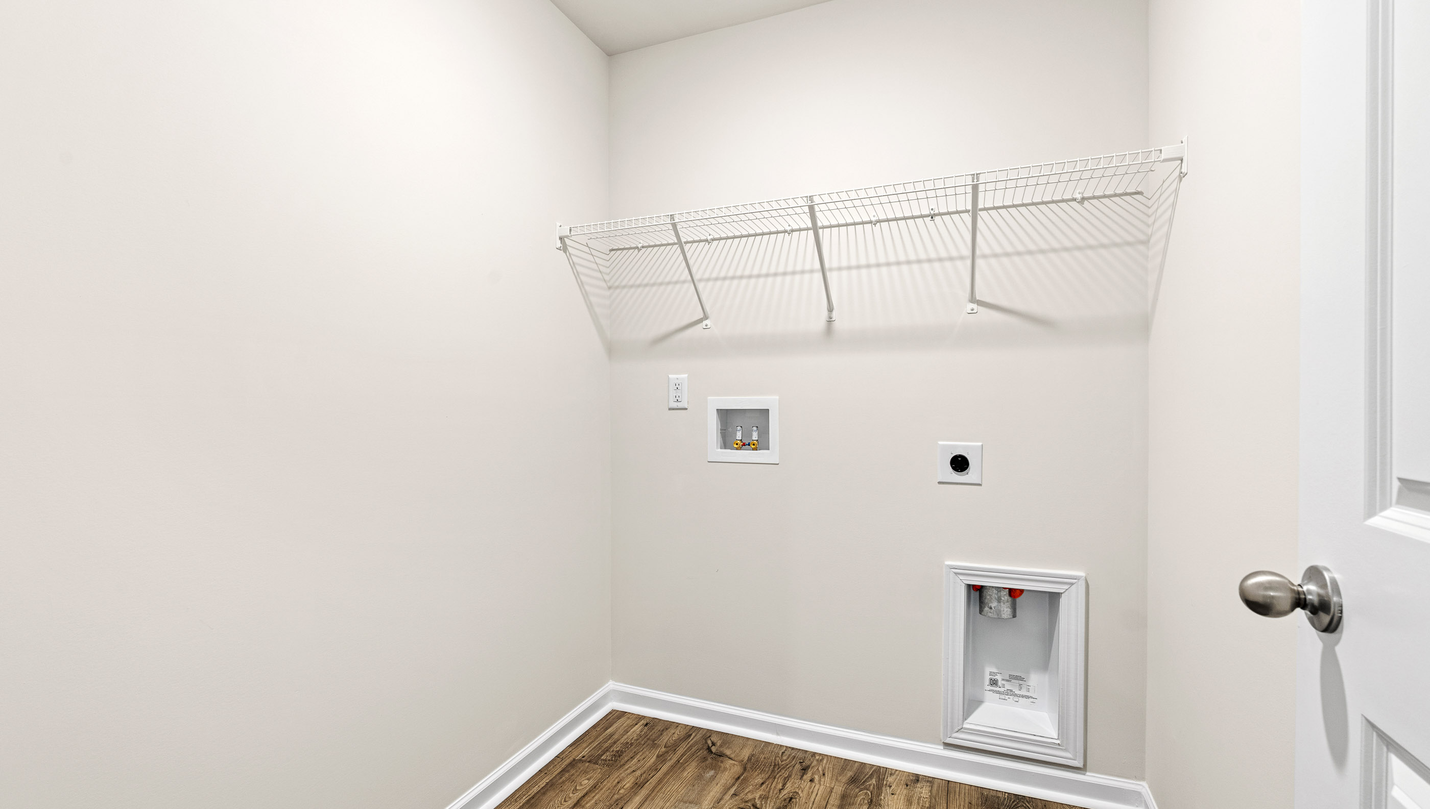 Walk in laundry with shelves.