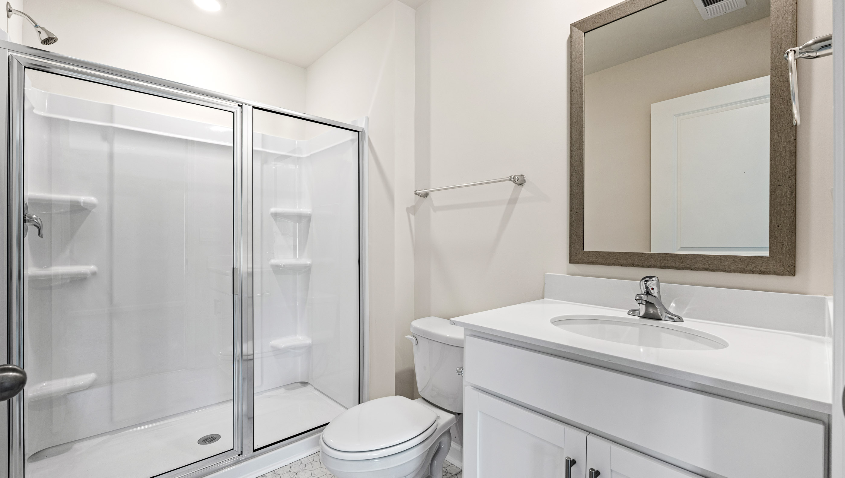Bathroom with vanity and walk in shower.