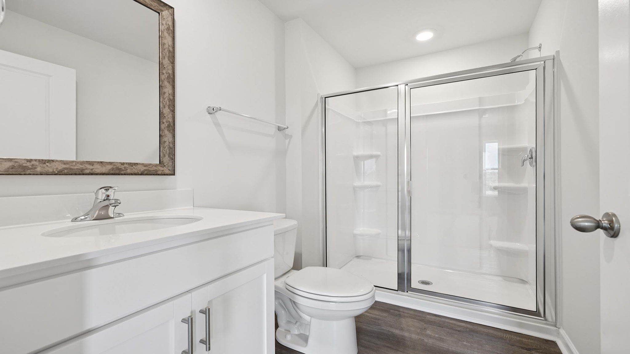 Bathroom with vanity and walk in shower.