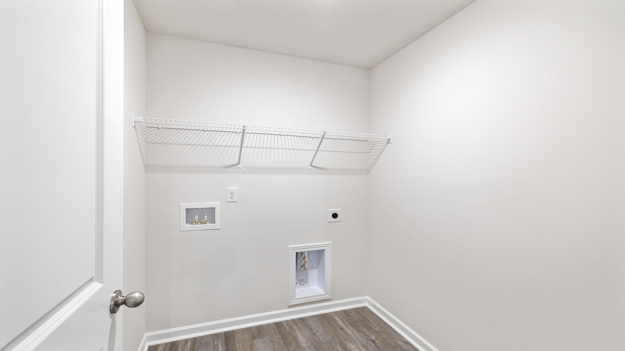 Walk in laundry with shelves.