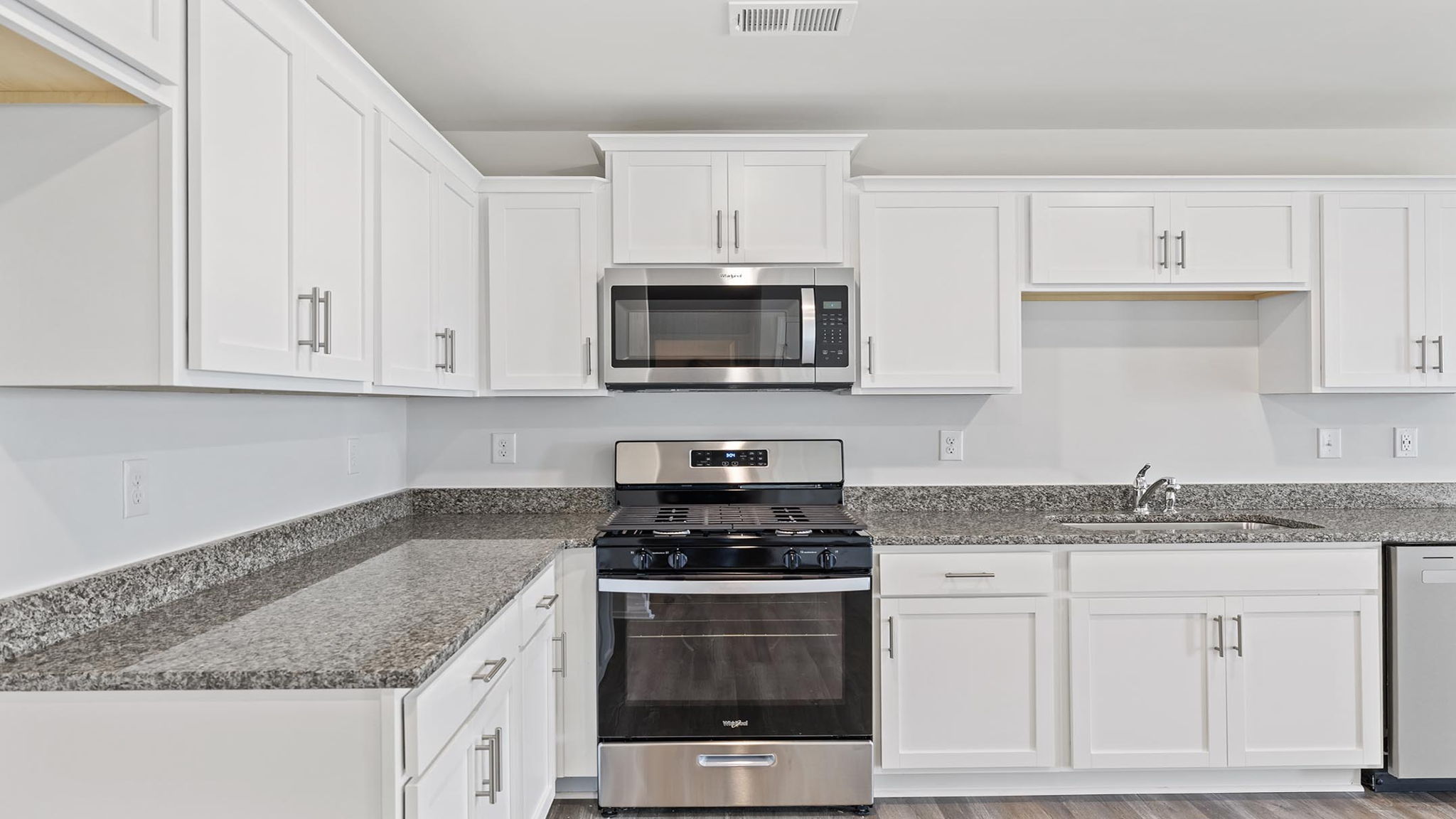 Kitchen with granite countertops and stainless steel appliances.