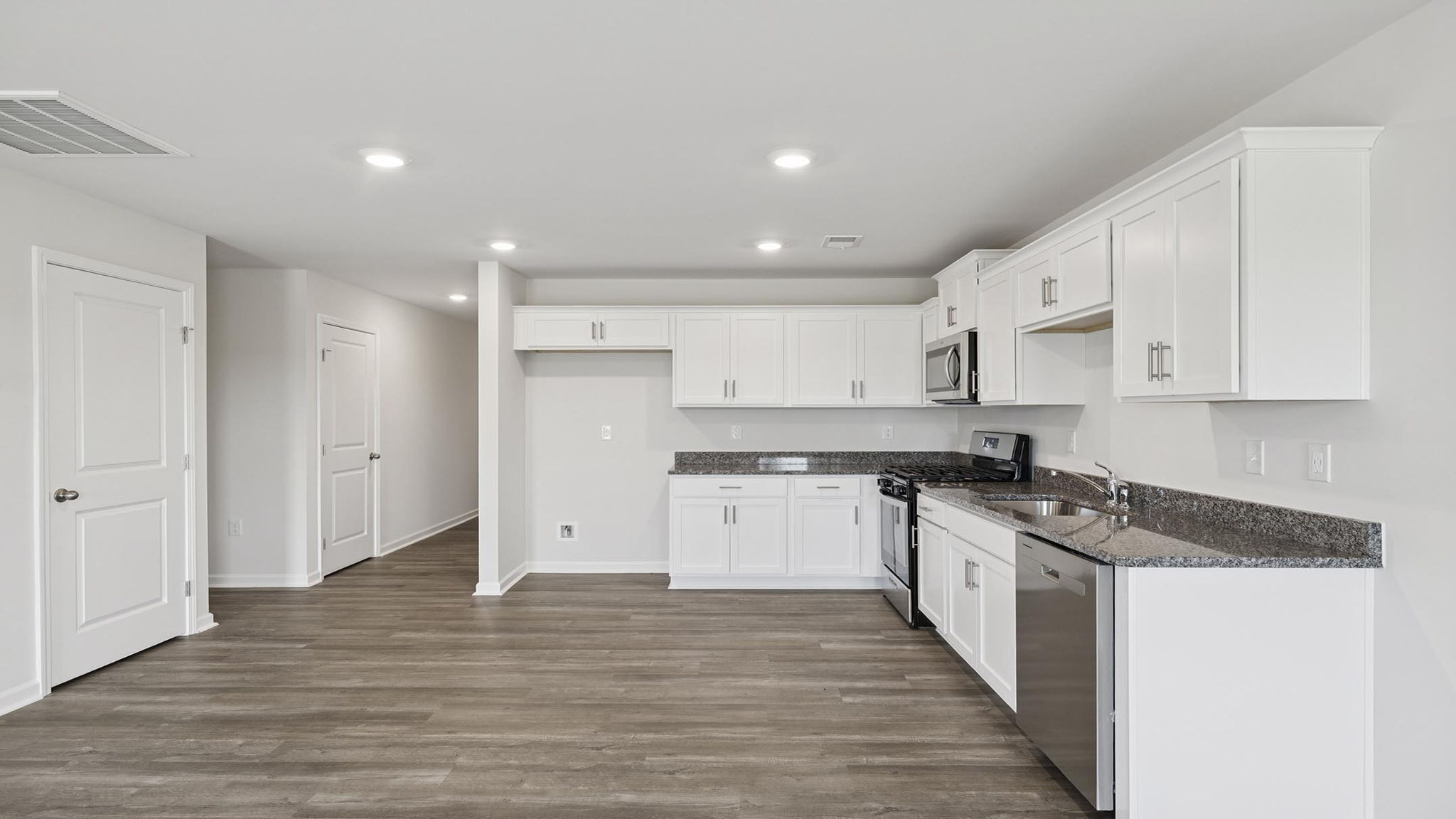 Kitchen with granite countertops and stainless steel appliances.