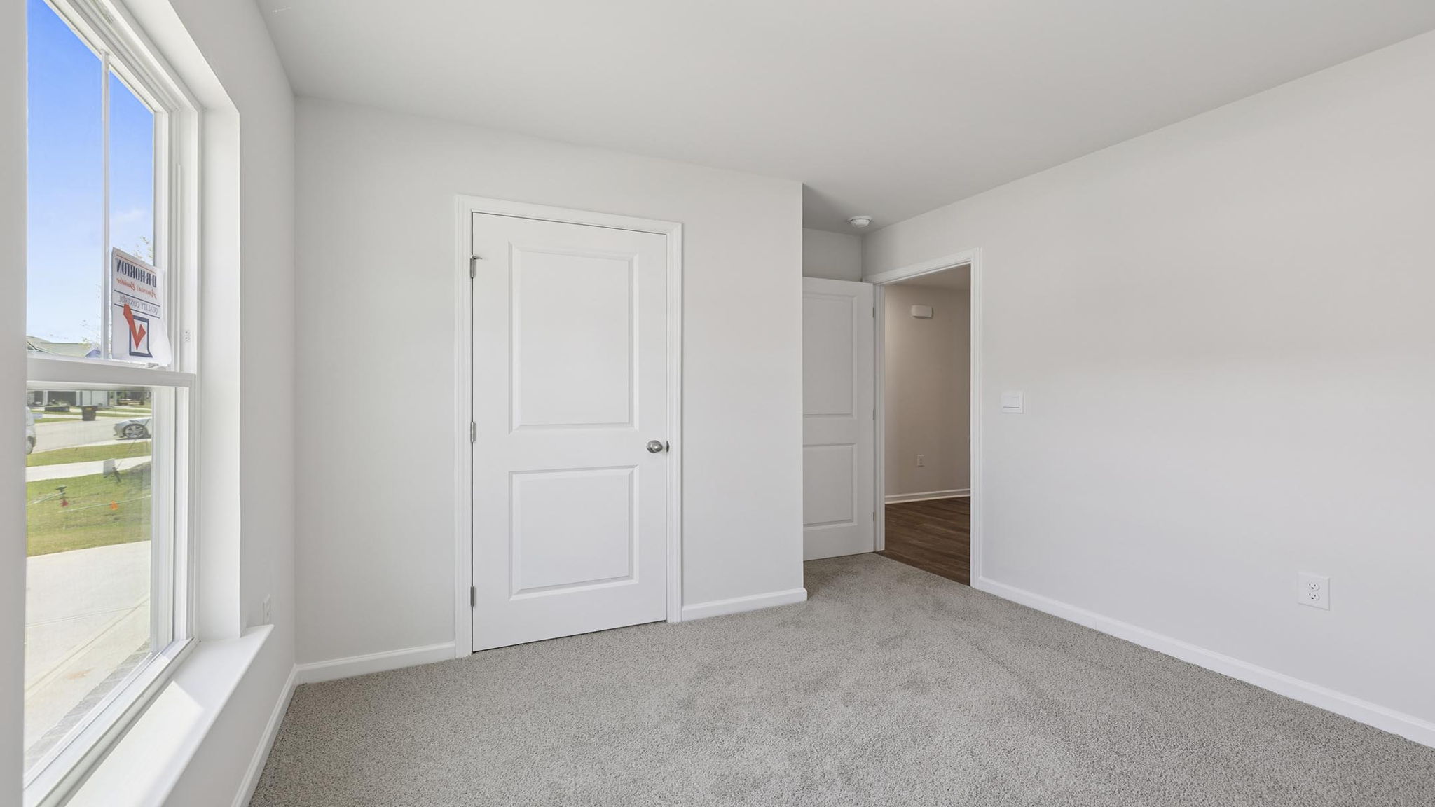 Bedroom with carpet and windows.