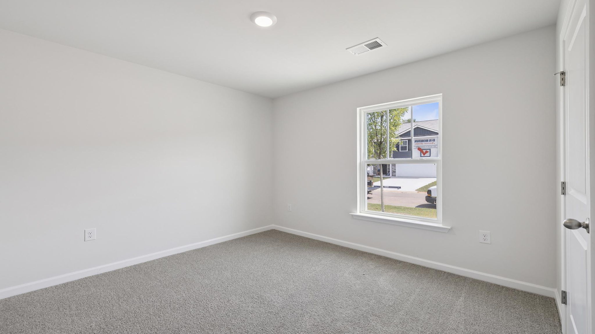 Bedroom with carpet and windows.