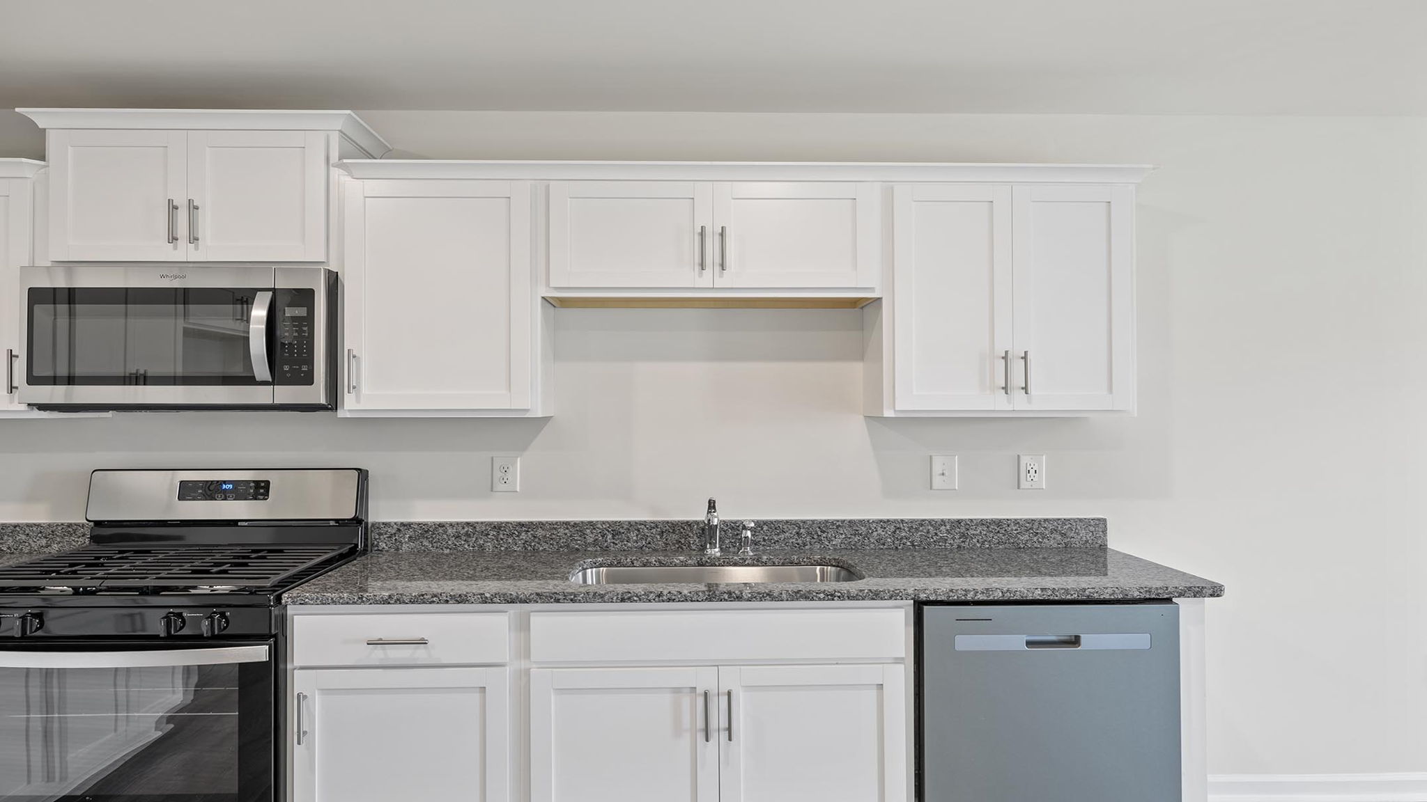 Kitchen with granite countertops and stainless steel appliances.