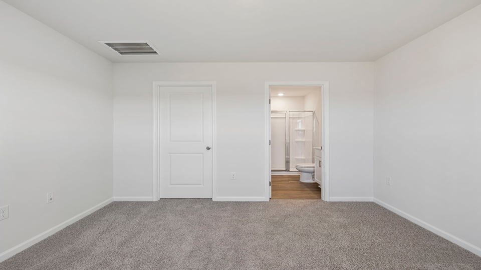 Bedroom with carpet and window.