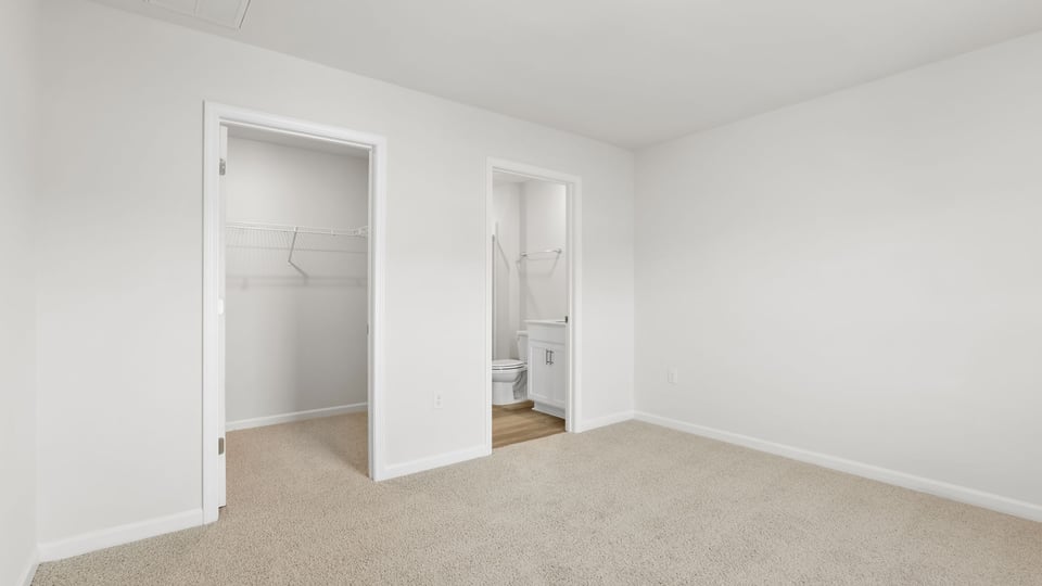 Bedroom with carpet and window.