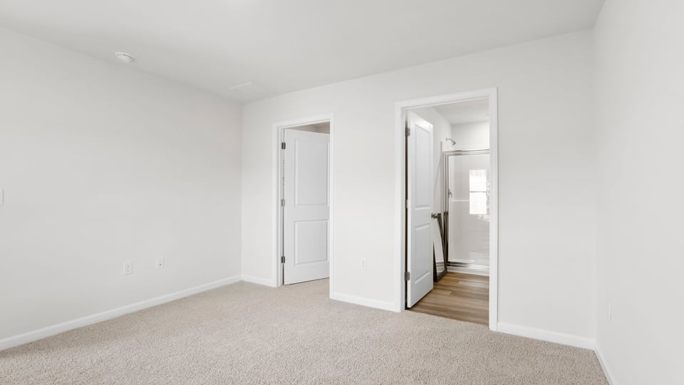 Bedroom with carpet and window.