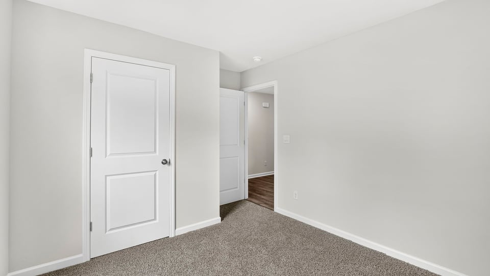 Bedroom with carpet and window.