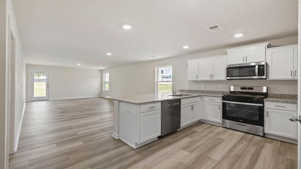 Kitchen with granite countertops and stainless steel appliances.
