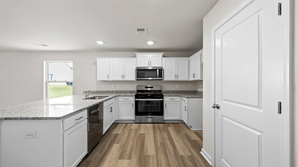 Kitchen with granite countertops and stainless steel appliances.