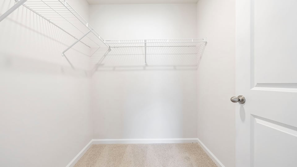Walk in closet with hanging shelves.