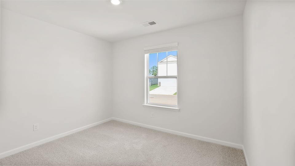 Bedroom with carpet and window.