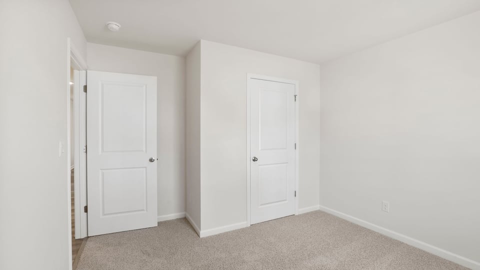 Bedroom with carpet and window.