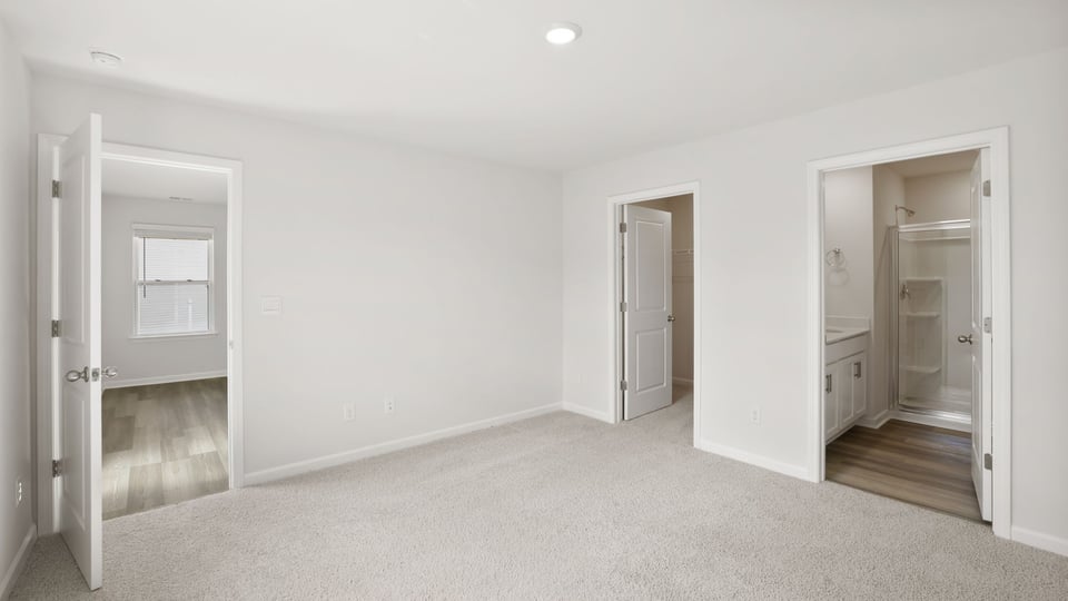 Bedroom with carpet and windows.