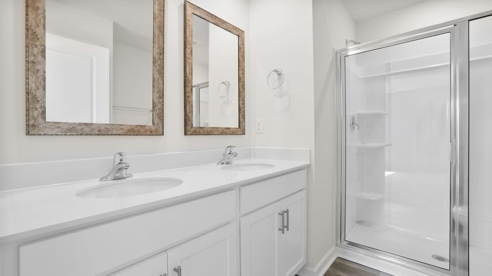 Bedroom with vanity and walk in shower.