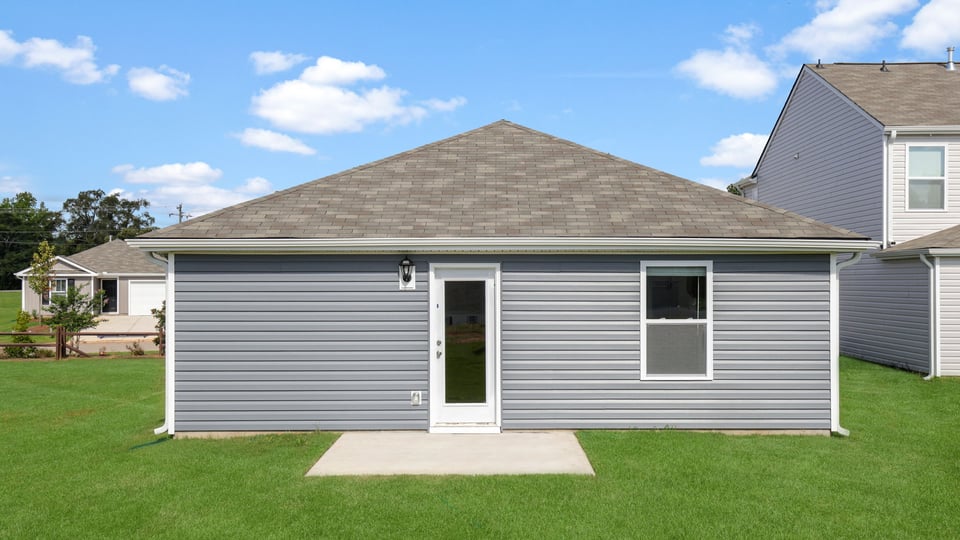 Exterior of home with large backyard.