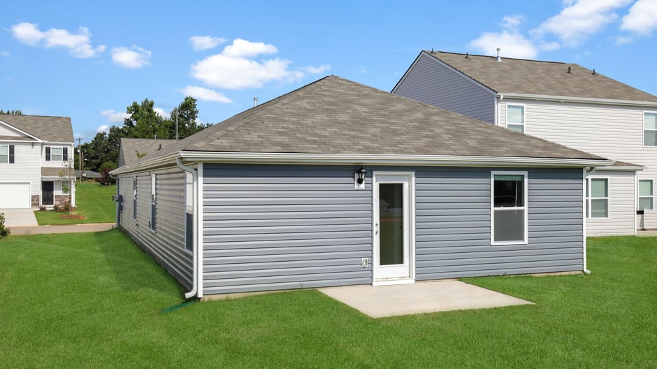 Exterior of home with large backyard.