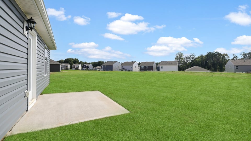 Exterior of home with large backyard.