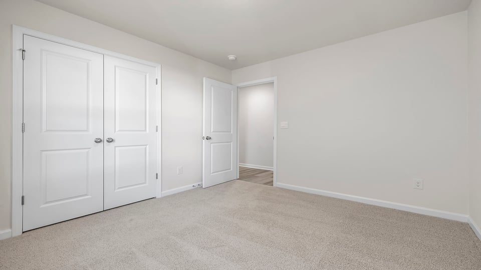 Bedroom with carpet and window.